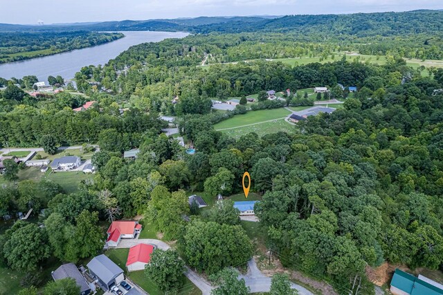 drone / aerial view featuring a water view and a view of trees