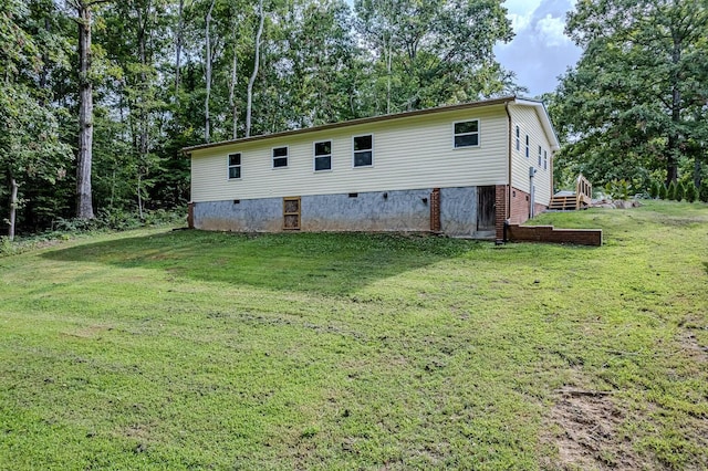 view of home's exterior with a lawn