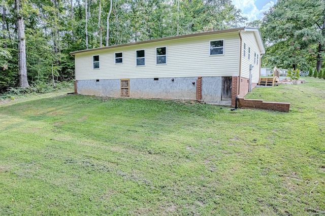 rear view of property featuring a yard
