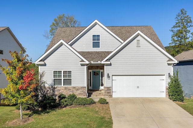 craftsman-style home featuring a front lawn and a garage