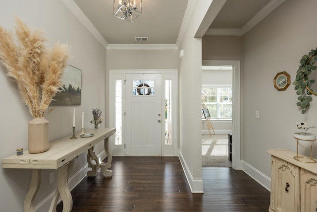 foyer entrance featuring ornamental molding and dark hardwood / wood-style flooring