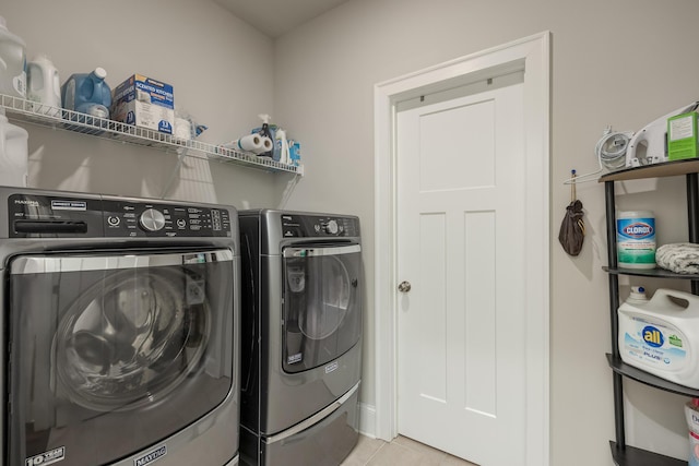 washroom featuring separate washer and dryer and light tile patterned floors