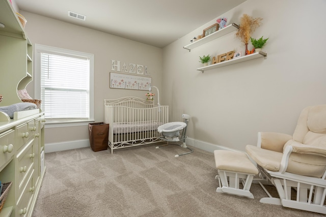 carpeted bedroom featuring a crib