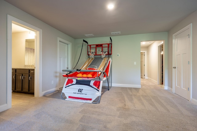 rec room featuring light colored carpet