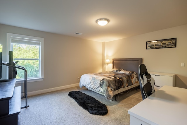 bedroom featuring light carpet