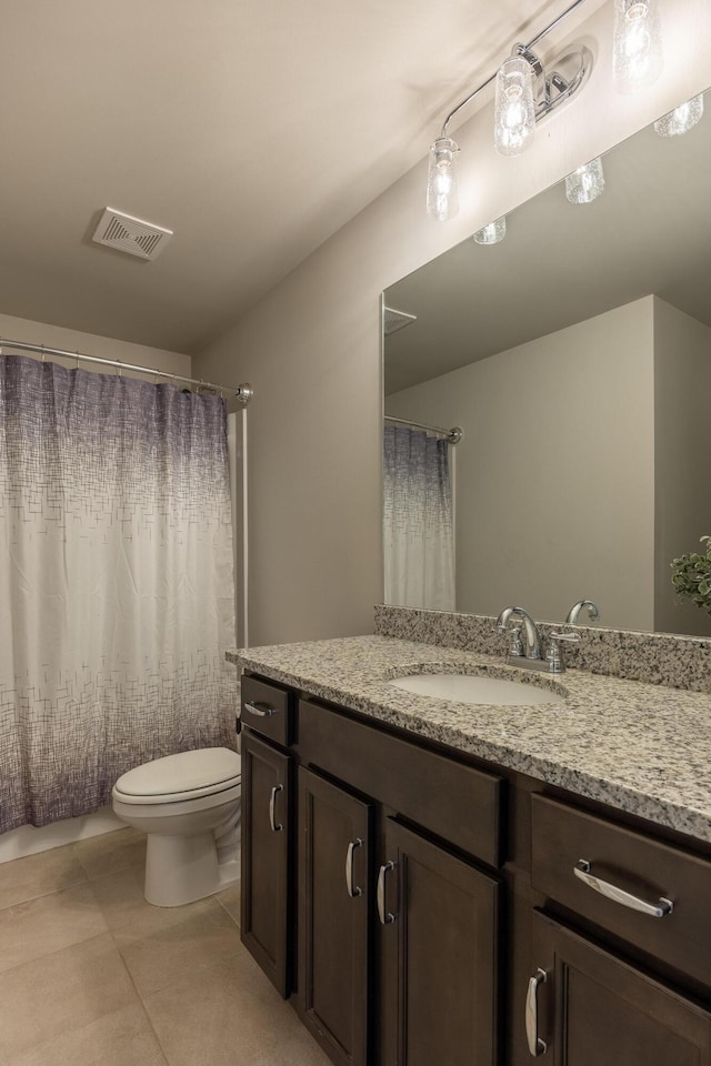 bathroom with vanity, toilet, and tile patterned floors