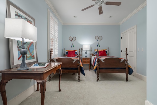 carpeted bedroom featuring ceiling fan and crown molding