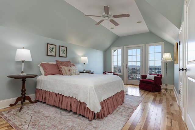 bedroom featuring ceiling fan, light hardwood / wood-style floors, vaulted ceiling, and access to exterior