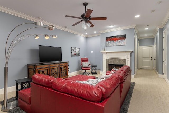 carpeted living room with a high end fireplace, ceiling fan, and ornamental molding