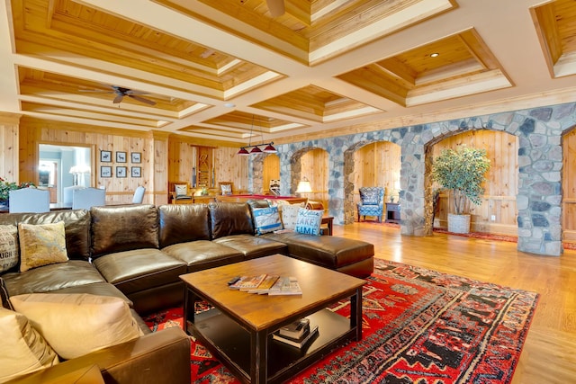 living room with crown molding, ceiling fan, coffered ceiling, and light hardwood / wood-style floors