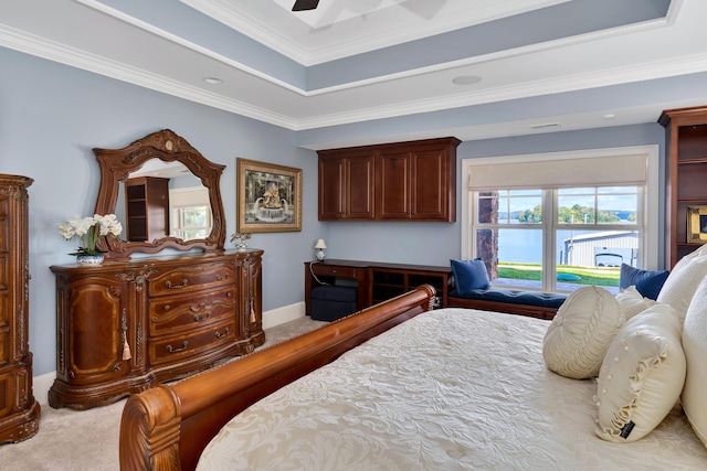 carpeted bedroom with crown molding, ceiling fan, and a raised ceiling