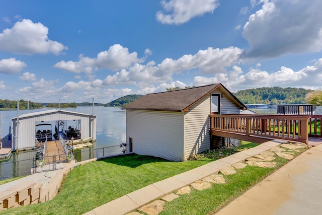 view of property exterior with a deck with water view and a lawn