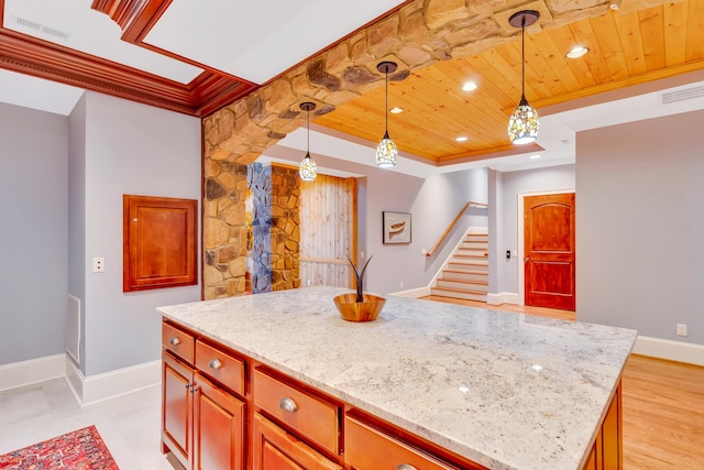 kitchen featuring light stone countertops, a kitchen island, pendant lighting, and wood ceiling