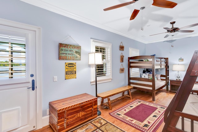 bedroom with ornamental molding, light hardwood / wood-style floors, and ceiling fan