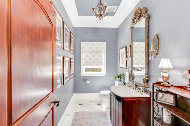 bathroom with crown molding, vanity, a chandelier, and toilet