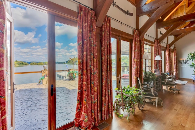 entryway with a water view, wood-type flooring, and french doors