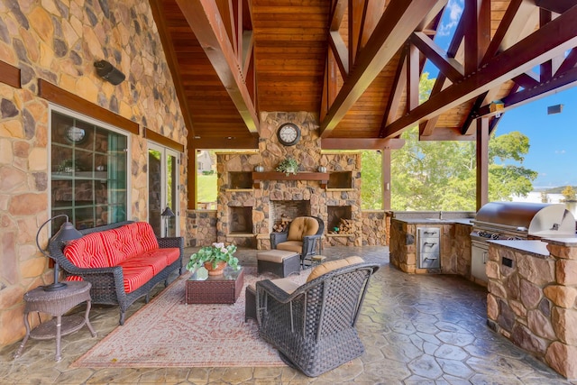 view of patio / terrace featuring a grill, an outdoor living space with a fireplace, and an outdoor kitchen