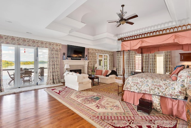 bedroom featuring hardwood / wood-style flooring, ceiling fan, ornamental molding, and access to exterior