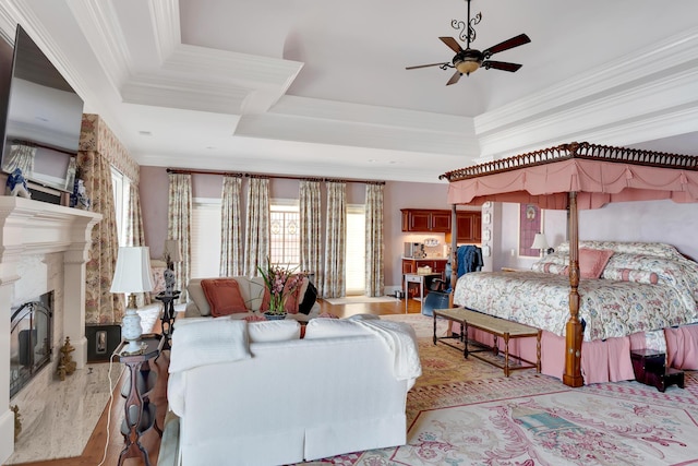 bedroom with ceiling fan, ornamental molding, a fireplace, and multiple windows