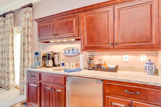 kitchen with fridge, ornamental molding, sink, and light stone counters