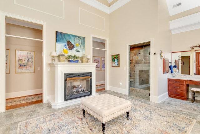 interior space with crown molding and a towering ceiling