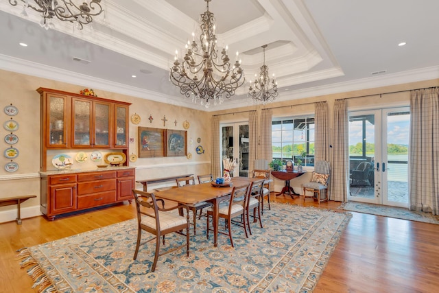 dining area featuring ornamental molding, french doors, and a raised ceiling