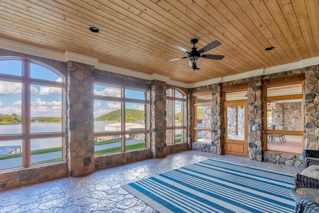 unfurnished sunroom with a wealth of natural light, wooden ceiling, ceiling fan, and a water view