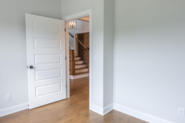 interior space with hardwood / wood-style flooring and a chandelier