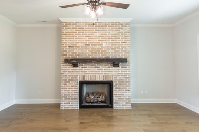 unfurnished living room featuring ceiling fan, crown molding, a fireplace, and hardwood / wood-style floors