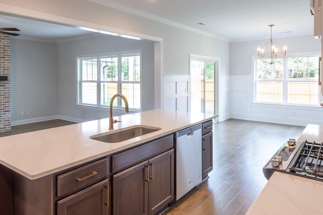 kitchen with stainless steel dishwasher, light stone countertops, sink, and a wealth of natural light