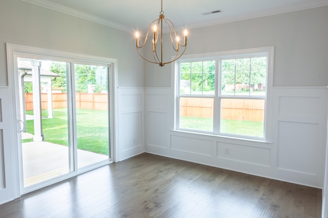 unfurnished dining area featuring ornamental molding, a chandelier, and dark hardwood / wood-style floors