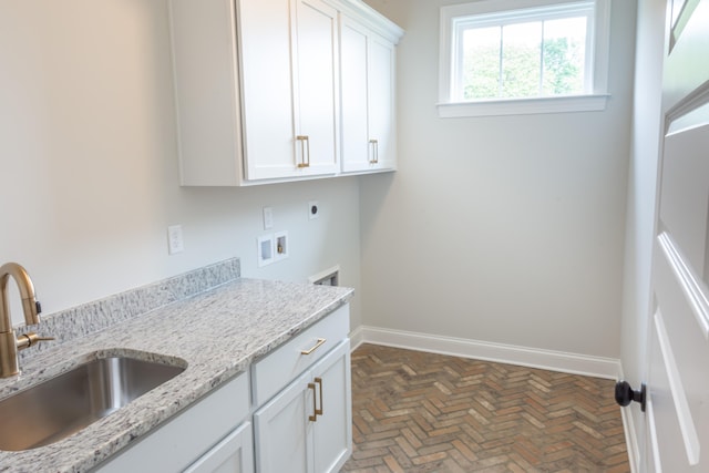 laundry area with cabinets, hookup for an electric dryer, sink, and washer hookup