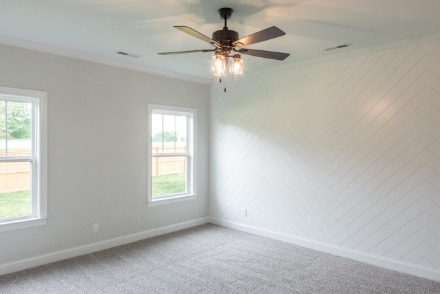 carpeted empty room with ornamental molding and ceiling fan