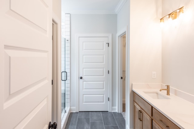 bathroom with vanity, crown molding, tile patterned floors, and a shower with shower door