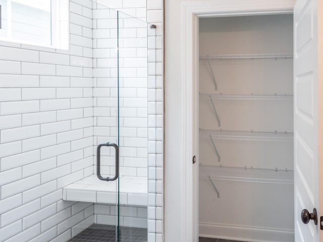 bathroom with a shower with shower door