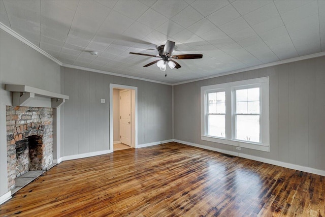 unfurnished living room featuring ceiling fan, hardwood / wood-style floors, ornamental molding, and a fireplace