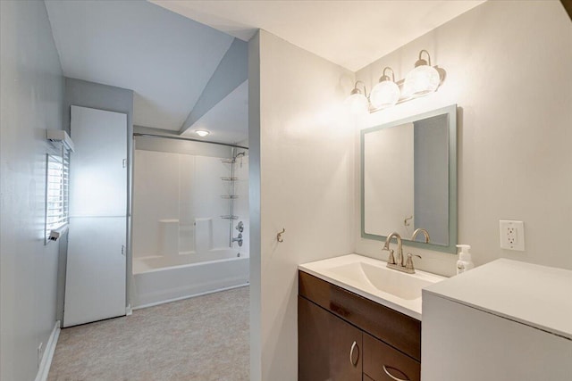 bathroom with shower / washtub combination, lofted ceiling, and vanity