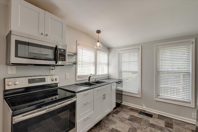 kitchen featuring hanging light fixtures, appliances with stainless steel finishes, sink, and white cabinets