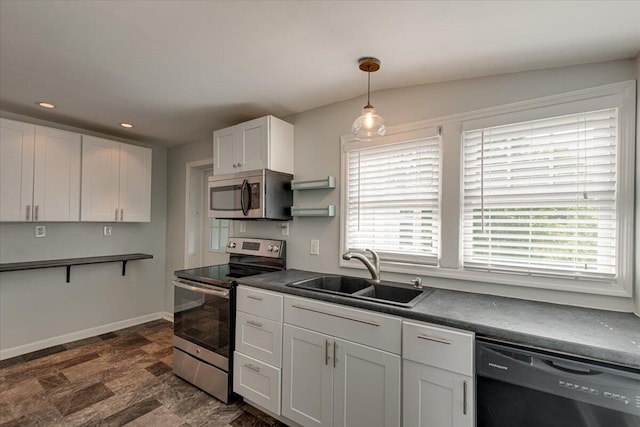 kitchen featuring white cabinets, appliances with stainless steel finishes, sink, and plenty of natural light