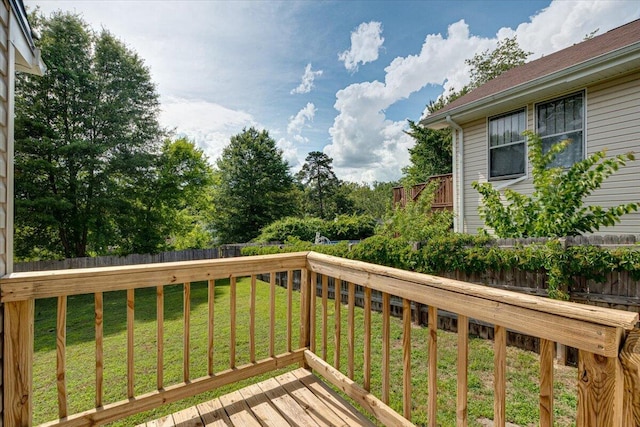 wooden terrace featuring a yard