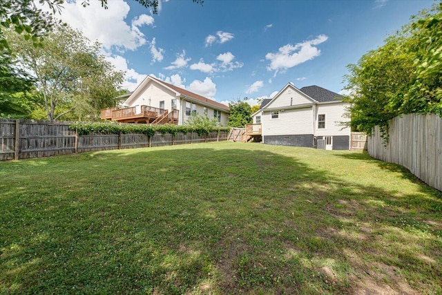 view of yard with central AC and a deck