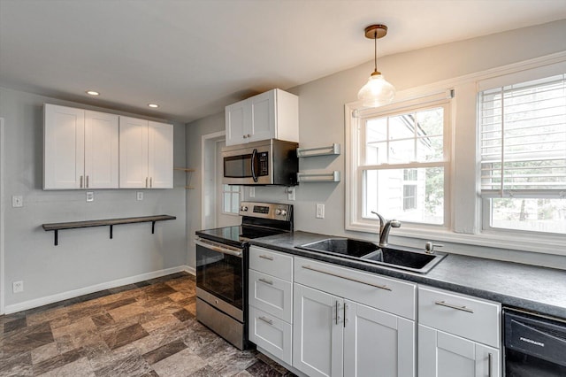 kitchen featuring white cabinetry, pendant lighting, sink, and stainless steel appliances