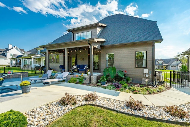 back of house with outdoor lounge area, a lawn, a patio, and ceiling fan