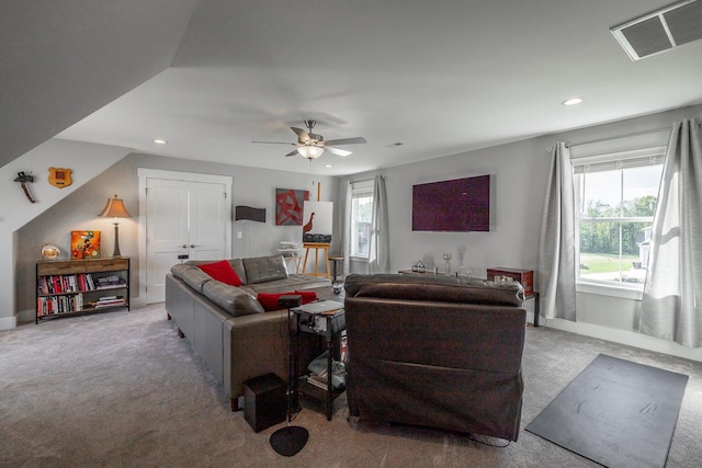 carpeted living room featuring ceiling fan