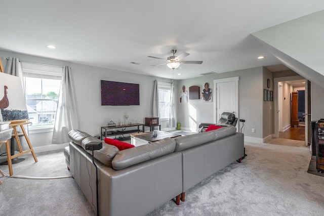 living room with ceiling fan and light colored carpet