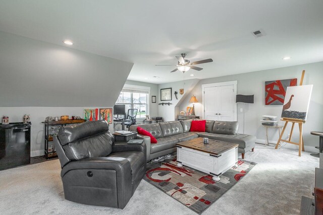 carpeted living room with vaulted ceiling and ceiling fan