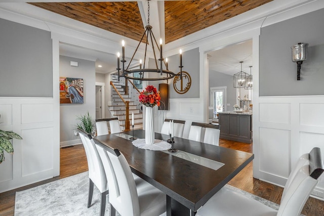 dining room with wood ceiling, vaulted ceiling, dark hardwood / wood-style floors, and a notable chandelier