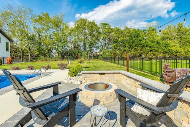 view of patio featuring a fenced in pool and an outdoor fire pit