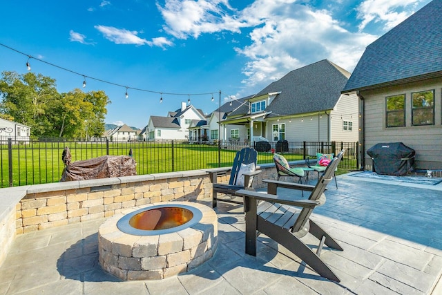 view of patio / terrace with a grill and a fire pit