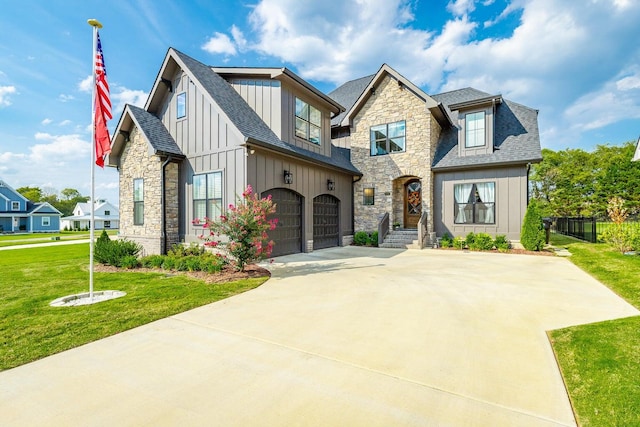 view of front of home featuring a front yard and a garage